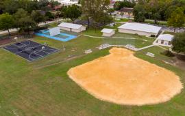 Aerial view of recreational fields and buildings at Jim Legrone Park: 2 basketball courts, 2 handball courts, 1 baseball field