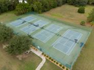 four tennis courts in one fenced in area