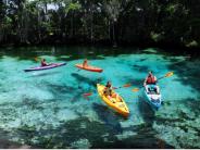 People kayaking on the clear water of the springs