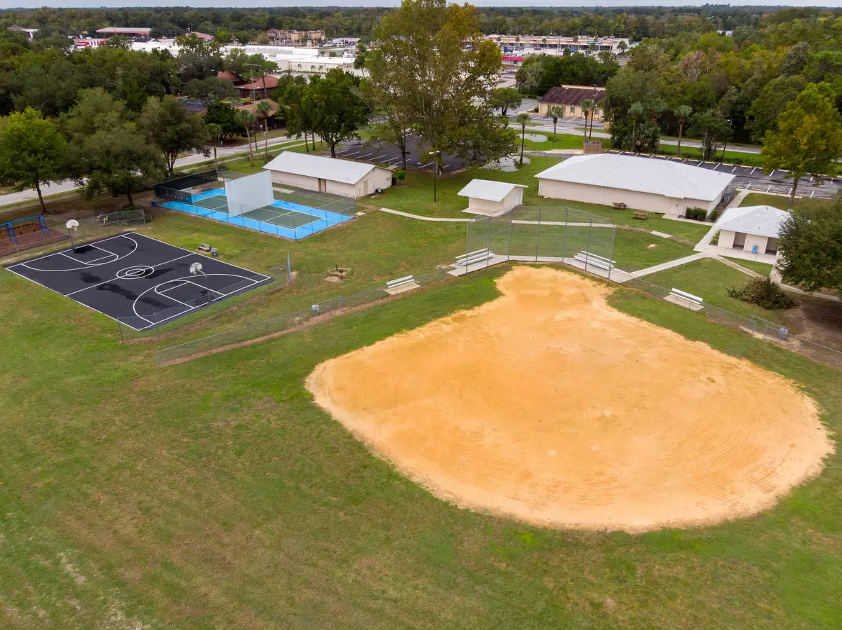 Aerial view of recreational fields and buildings at Jim Legrone Park: 2 basketball courts, 2 handball courts, 1 baseball field