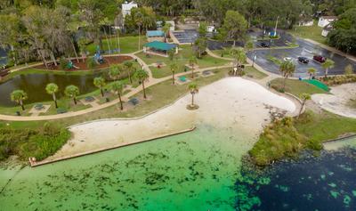 View of beach area as viewed from the water showing clear water and small sandy beach area